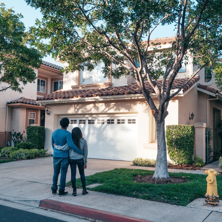 People standing outside of their home